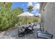 Outdoor dining area with a large patio table, seating for six, and lush landscaping for privacy at 4430 Angelo Rosa St, Las Vegas, NV 89135