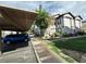 Exterior view of the condo with covered parking, landscaping, and a sidewalk at 45 Maleena Mesa St # 1321, Henderson, NV 89074