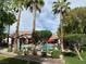 Community swimming pool with palm trees, lounge chairs, tables, and fencing at 45 Maleena Mesa St # 1321, Henderson, NV 89074
