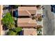Overhead view of closely situated houses with red tiled roofs, landscaped yards, and paved driveways on a sunny day at 5438 Jacobs Field St, Las Vegas, NV 89148