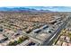 Expansive aerial view showcasing the residential community, mountain views, and commercial buildings at 5438 Jacobs Field St, Las Vegas, NV 89148