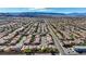 Expansive aerial view of a meticulously planned community with uniform houses, wide streets, and scenic mountain backdrop at 5438 Jacobs Field St, Las Vegas, NV 89148