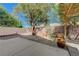 Serene backyard patio with a wooden pergola, mature tree, and desert landscaping at 5438 Jacobs Field St, Las Vegas, NV 89148
