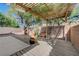 Picturesque backyard patio with desert landscaping, featuring a wooden pergola, great for outdoor gatherings at 5438 Jacobs Field St, Las Vegas, NV 89148