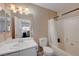 Bathroom features a single sink vanity with white cabinets and a shower-tub combo at 5438 Jacobs Field St, Las Vegas, NV 89148