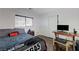 Bedroom featuring hardwood floors, window, and a small desk and drawers at 5438 Jacobs Field St, Las Vegas, NV 89148