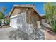 Close-up of a single-story house with a two-car garage, landscaped yard, and a desert style landscape at 5438 Jacobs Field St, Las Vegas, NV 89148