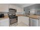 Bright kitchen with stainless steel appliances, white cabinetry, and granite countertops at 5438 Jacobs Field St, Las Vegas, NV 89148
