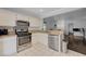 Bright kitchen with stainless steel appliances and white cabinetry at 5438 Jacobs Field St, Las Vegas, NV 89148