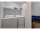 Laundry area featuring a washer and dryer set with a shelf for storage at 5438 Jacobs Field St, Las Vegas, NV 89148