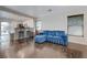 Bright living room with wood floors and a view to the kitchen with a comfortable blue sofa at 5438 Jacobs Field St, Las Vegas, NV 89148