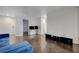 Bright living room with wood floors, comfortable blue sofa, and an open floor plan at 5438 Jacobs Field St, Las Vegas, NV 89148