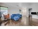 Bright living room with wood floors, a comfortable blue sofa, and modern decor at 5438 Jacobs Field St, Las Vegas, NV 89148