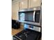 Stainless steel Whirlpool microwave above the gas range in the kitchen at 5438 Jacobs Field St, Las Vegas, NV 89148