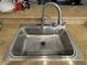 Deep stainless steel kitchen sink with updated faucet and granite countertops at 5438 Jacobs Field St, Las Vegas, NV 89148