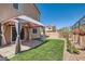 A beautifully landscaped backyard with artificial grass, a gazebo, and manicured hedges at 5556 Cornadelo Range Rd, Las Vegas, NV 89113