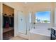 Bright bathroom with a glass enclosed shower, soaking tub and walk-in closet at 5556 Cornadelo Range Rd, Las Vegas, NV 89113