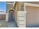 Close-up of the front entrance and garage, highlighting the neutral color palette at 5556 Cornadelo Range Rd, Las Vegas, NV 89113