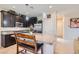 Modern kitchen with dark wood cabinetry, stainless steel appliances, and a granite counter island at 5556 Cornadelo Range Rd, Las Vegas, NV 89113