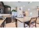 Well-equipped kitchen with stainless steel appliances, a large island, and dark cabinets at 5556 Cornadelo Range Rd, Las Vegas, NV 89113
