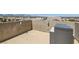 View of a simple rooftop deck area with patio furniture and neighborhood views at 5556 Cornadelo Range Rd, Las Vegas, NV 89113