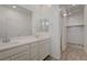 Stylish bathroom with dual sinks, modern lighting, and access to walk-in closet at 5730 Sky Pointe Dr # 104, Las Vegas, NV 89130