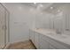 Bathroom boasts double sink vanity with a walk-in shower with bright, neutral finishes at 5730 Sky Pointe Dr # 104, Las Vegas, NV 89130