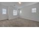 Bright bedroom with neutral carpet, white walls, and multiple windows at 5730 Sky Pointe Dr # 104, Las Vegas, NV 89130