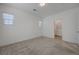 Neutral bedroom with view to bathroom; features plush carpet, white walls, and natural lighting at 5730 Sky Pointe Dr # 104, Las Vegas, NV 89130