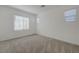 Bright bedroom with carpeting and natural light from two windows at 5730 Sky Pointe Dr # 104, Las Vegas, NV 89130