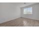 Bright bedroom features a large window, wood-look flooring, and ample space at 5730 Sky Pointe Dr # 104, Las Vegas, NV 89130
