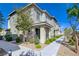 Charming two-story townhome with a well-maintained walkway and inviting curb appeal on a bright, sunny day at 5730 Sky Pointe Dr # 104, Las Vegas, NV 89130