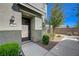 Charming home featuring a covered entrance and lovely green shrubbery in the front yard at 5730 Sky Pointe Dr # 104, Las Vegas, NV 89130