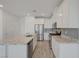 Bright kitchen features white cabinets, stainless steel appliances, granite countertops, and tile backsplash at 5730 Sky Pointe Dr # 104, Las Vegas, NV 89130