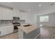 Bright kitchen with a large island, stainless steel appliances, and stylish countertops at 5730 Sky Pointe Dr # 104, Las Vegas, NV 89130