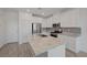 Modern kitchen with granite countertops, stainless steel appliances, a center island and white cabinets at 5730 Sky Pointe Dr # 104, Las Vegas, NV 89130