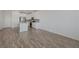 Open-concept living area boasts wood-look flooring, modern kitchen, and abundant natural light at 5730 Sky Pointe Dr # 104, Las Vegas, NV 89130