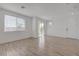 Spacious living room features wood-look flooring and sliding glass doors to the balcony at 5730 Sky Pointe Dr # 104, Las Vegas, NV 89130