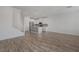 Spacious open-concept living area with wood-look flooring flowing into a bright, modern kitchen at 5730 Sky Pointe Dr # 104, Las Vegas, NV 89130