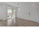 Bright living room features wood-look flooring and sliding glass doors to a private balcony at 5730 Sky Pointe Dr # 104, Las Vegas, NV 89130