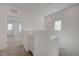 Bright loft area featuring a built-in cabinet and access to carpeted bedrooms at 5730 Sky Pointe Dr # 104, Las Vegas, NV 89130