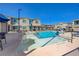 Refreshing community pool with accessible ramp, surrounded by lounge chairs and well-maintained fencing at 5730 Sky Pointe Dr # 104, Las Vegas, NV 89130