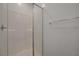 Bright white tiled walk-in shower features glass door and sleek chrome hardware at 5730 Sky Pointe Dr # 104, Las Vegas, NV 89130