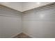 Spacious walk-in closet with carpet and wood rods for optimal storage at 5730 Sky Pointe Dr # 104, Las Vegas, NV 89130