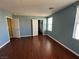 Bedroom with wood-look floors, closet, and multiple entryways with natural light from windows at 5846 Lee Fairy Ct, Las Vegas, NV 89139