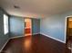 Bright bedroom showcasing wood-look floors and a view into the ensuite bathroom at 5846 Lee Fairy Ct, Las Vegas, NV 89139
