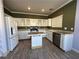 Bright kitchen with white cabinetry, stainless steel appliances, light countertops, and an island with bar seating at 5846 Lee Fairy Ct, Las Vegas, NV 89139