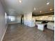 Open-concept layout with tiled floors, designer accent wall, recessed lighting, and seamless transition to the kitchen at 5846 Lee Fairy Ct, Las Vegas, NV 89139