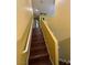 Staircase with hardwood steps and a yellow-painted wall leading upstairs at 5846 Lee Fairy Ct, Las Vegas, NV 89139