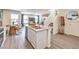 Open-concept kitchen features modern appliances, an island with seating, flowing into the dining and living areas at 6144 Aster Garden St # 133, North Las Vegas, NV 89081